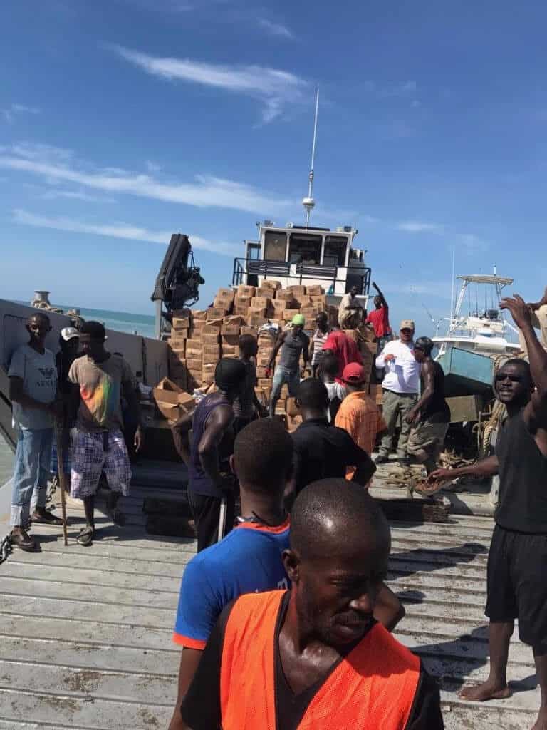 Haiti barge with meals being unloaded